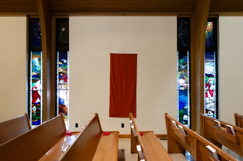 Inside of the church showing pews and stained glass